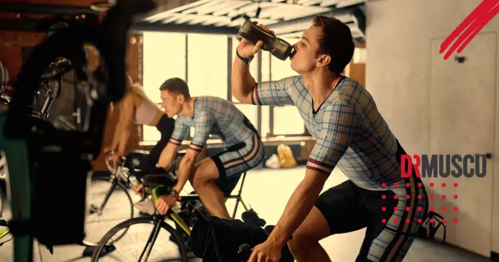 Hommes en salle de sport, cyclisme et hydratation.
